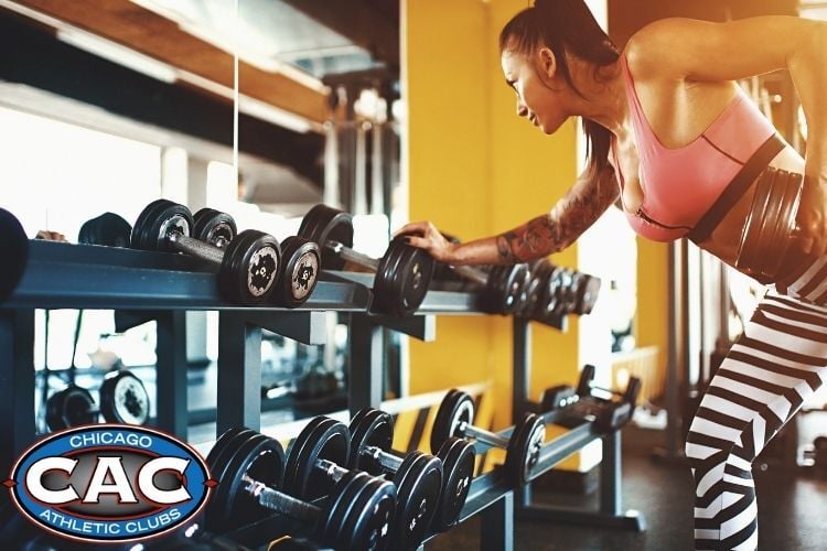 Woman doing dumbbell exercise in gym