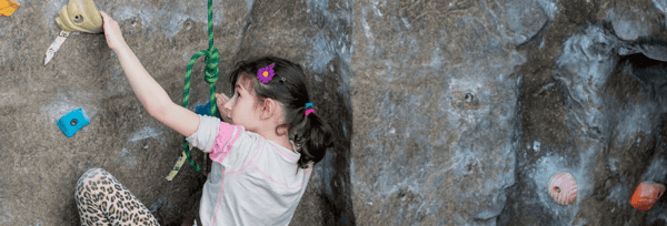 Girl climbing landing page header crop.png
