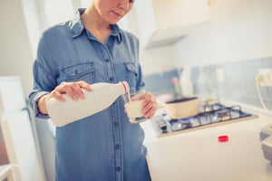 Woman pouring milk