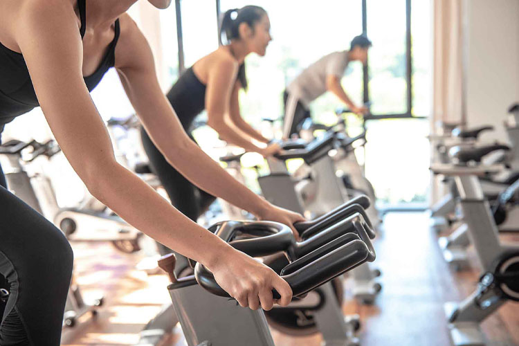 indoor cycling class with people on stationary bikes